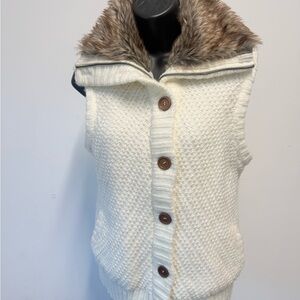 This is a Ci Sono cream knit sweater vest with a faux fur collar. 
Sleeveless